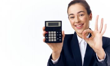 Woman,With,Calculator,And,Approving,Gesture